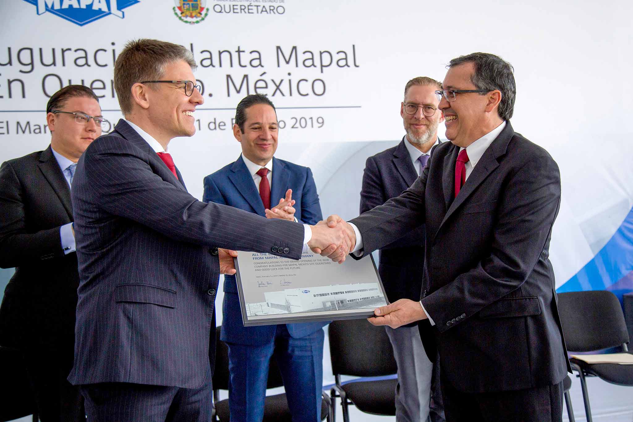 In the foreground, Dr Jochen Kress hands over a commemorative plaque to Lazaro Garza Sr. at the opening of the site. 