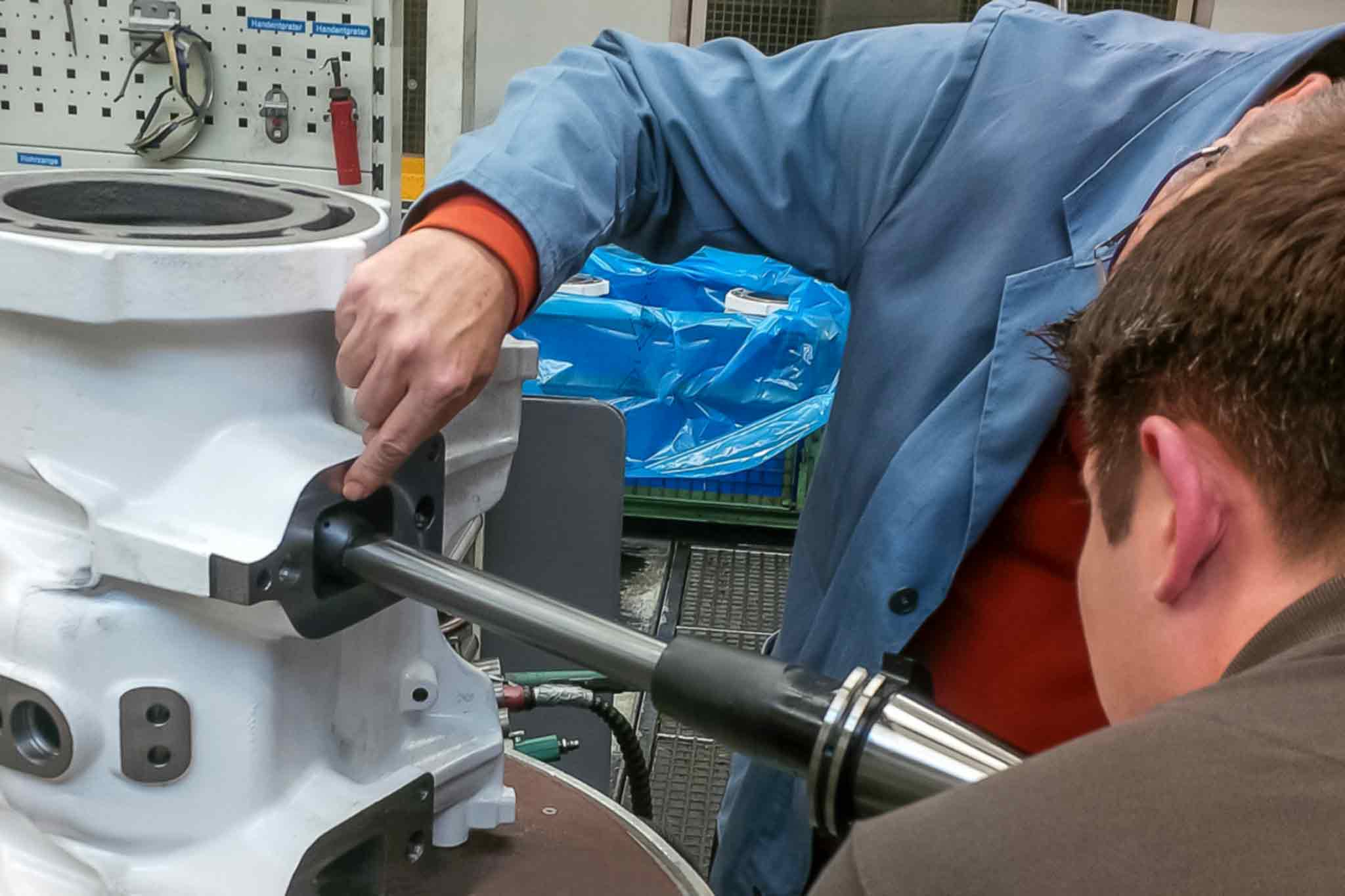 Someone inserts the tool into an inlet opening on the housing opposite the mounting surface. 