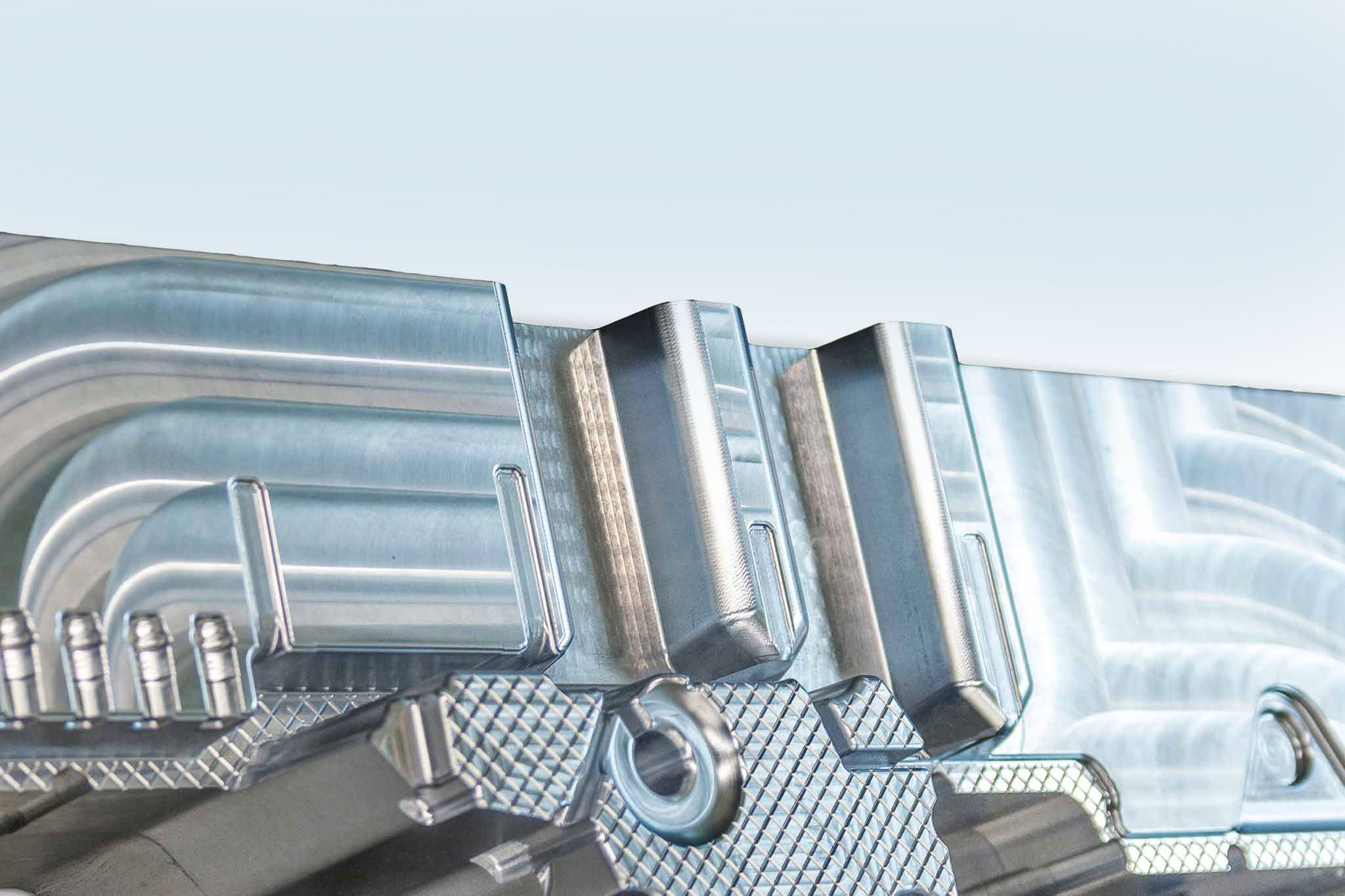 The picture shows a section of a mould for a battery tray with complex open spaces.
