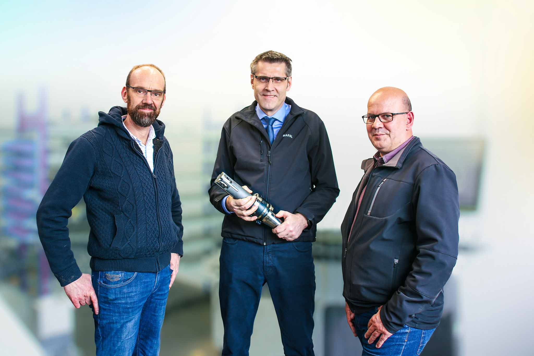 Ansgar Schumacher, Ralf Herlich with the MAPAL fine boring tool and Frank Pfeiler in the Schumacher manufacturing department. 
