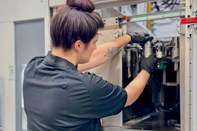 An application engineer works on the machine