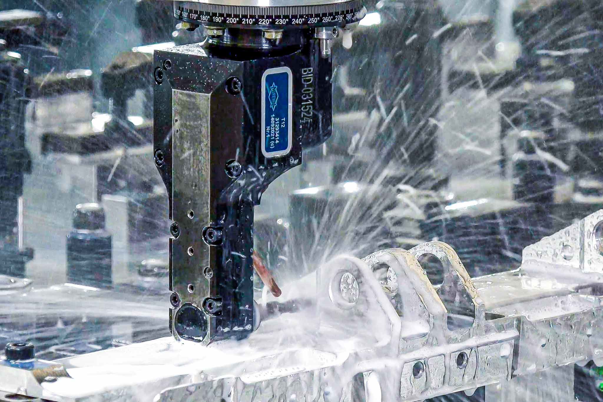 A right-angle drill head in use for titanium machining.